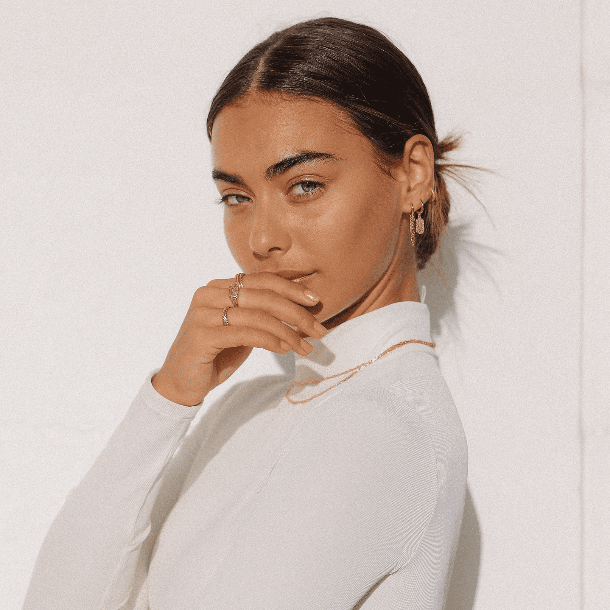 arms of eve mendoza gold huggie earrings on model