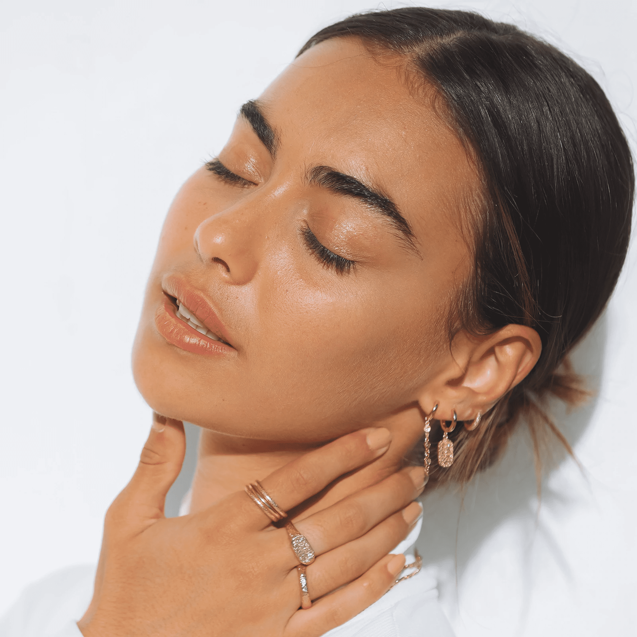 arms of eve mendoza gold huggie earrings on model