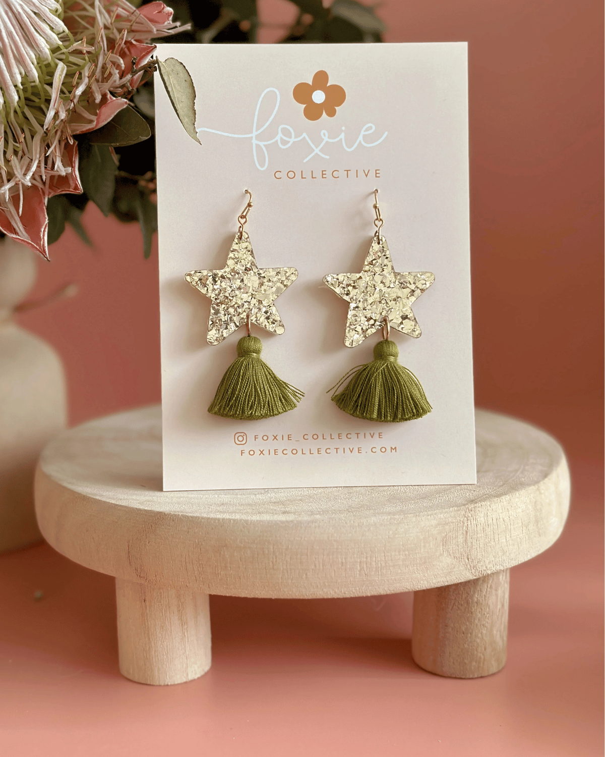 Hand drawn star design made from beautiful gold sparkle acrylic with an olive green tassel
