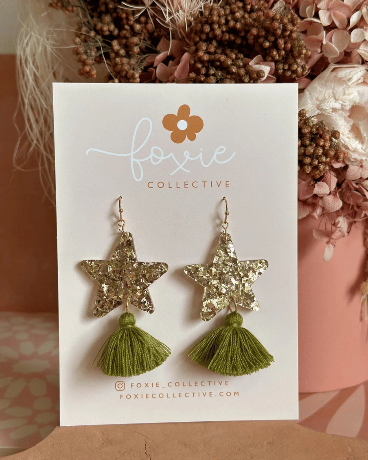 Hand drawn star design made from beautiful gold sparkle acrylic with an olive green tassel
