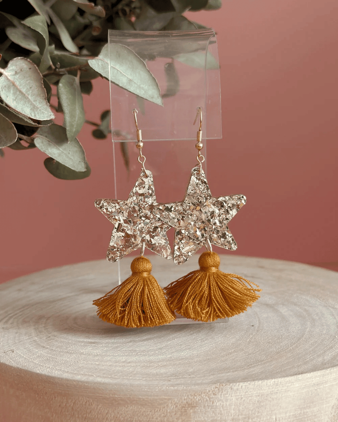 Hand drawn star design made from beautiful gold sparkle acrylic with a tan tassel