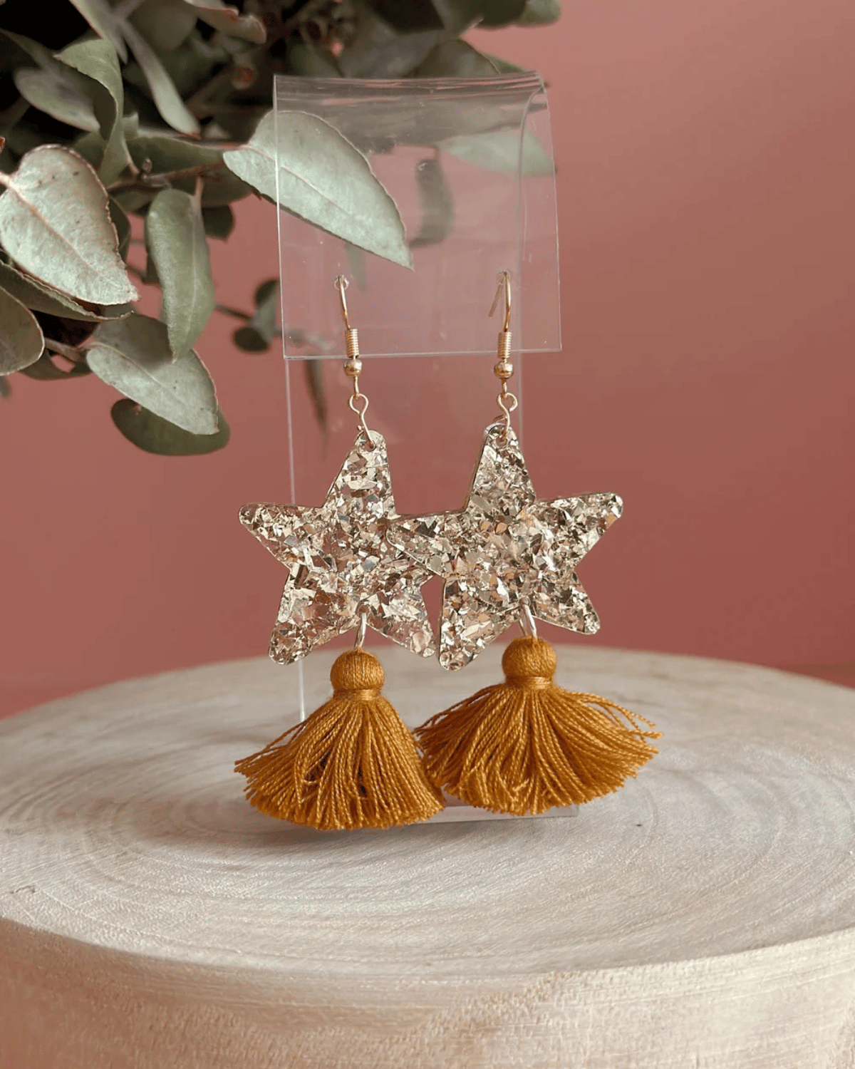 Hand drawn star design made from beautiful gold sparkle acrylic with a tan tassel
