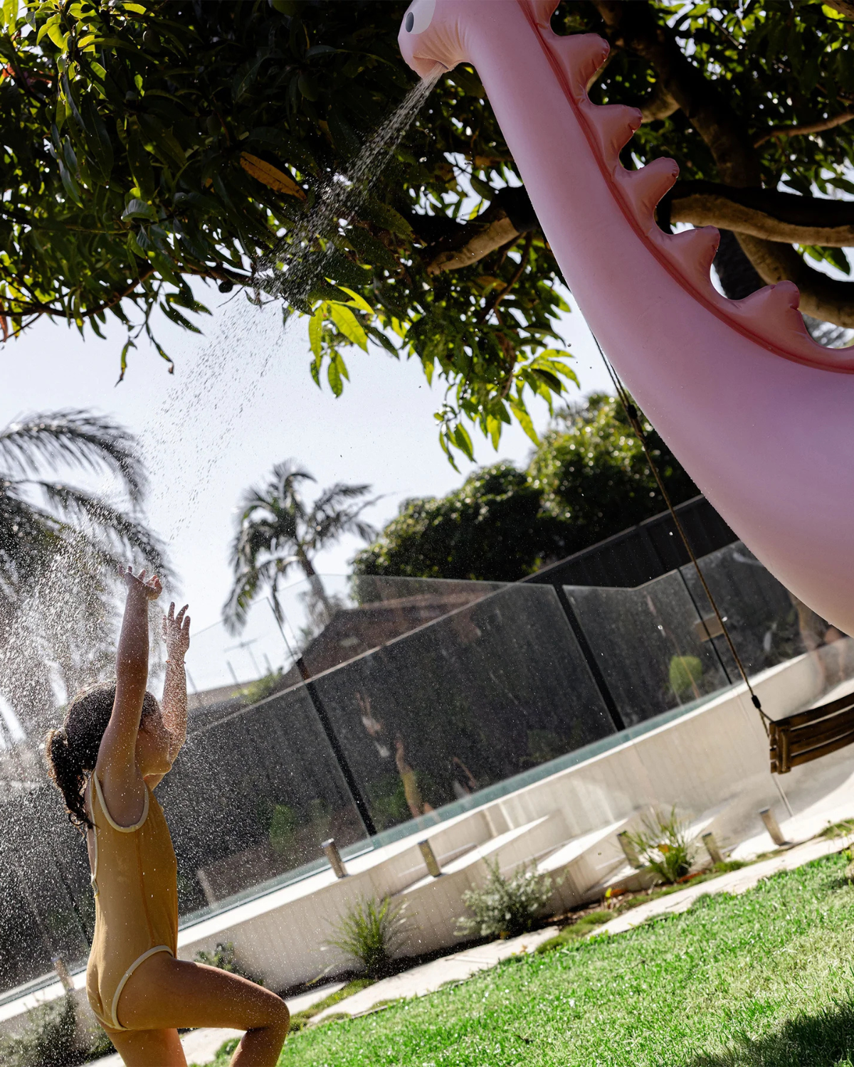 The Inflatable Giant Dino Sprinkler by SUNNYLiFE in Pink