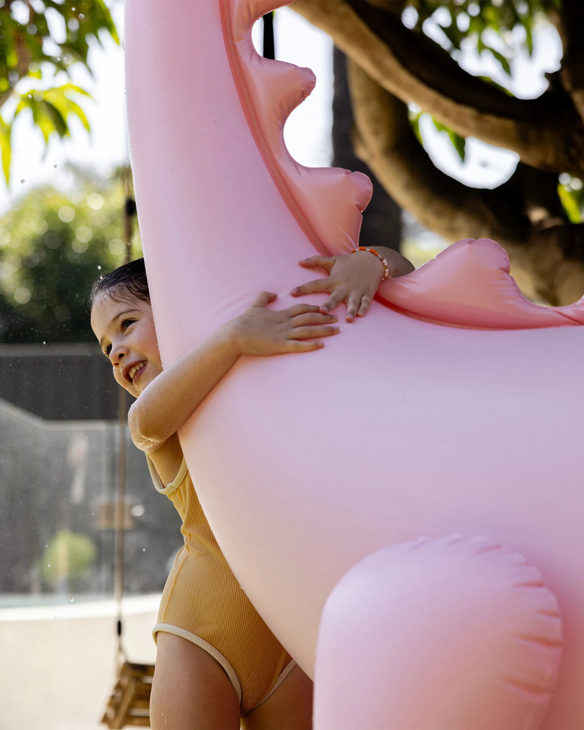 The Inflatable Giant Dino Sprinkler by SUNNYLiFE in Pink