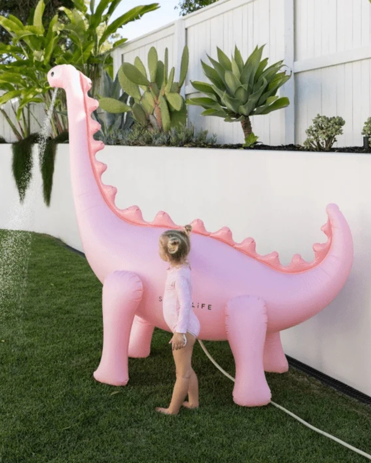 The Inflatable Giant Dino Sprinkler by SUNNYLiFE in Pink