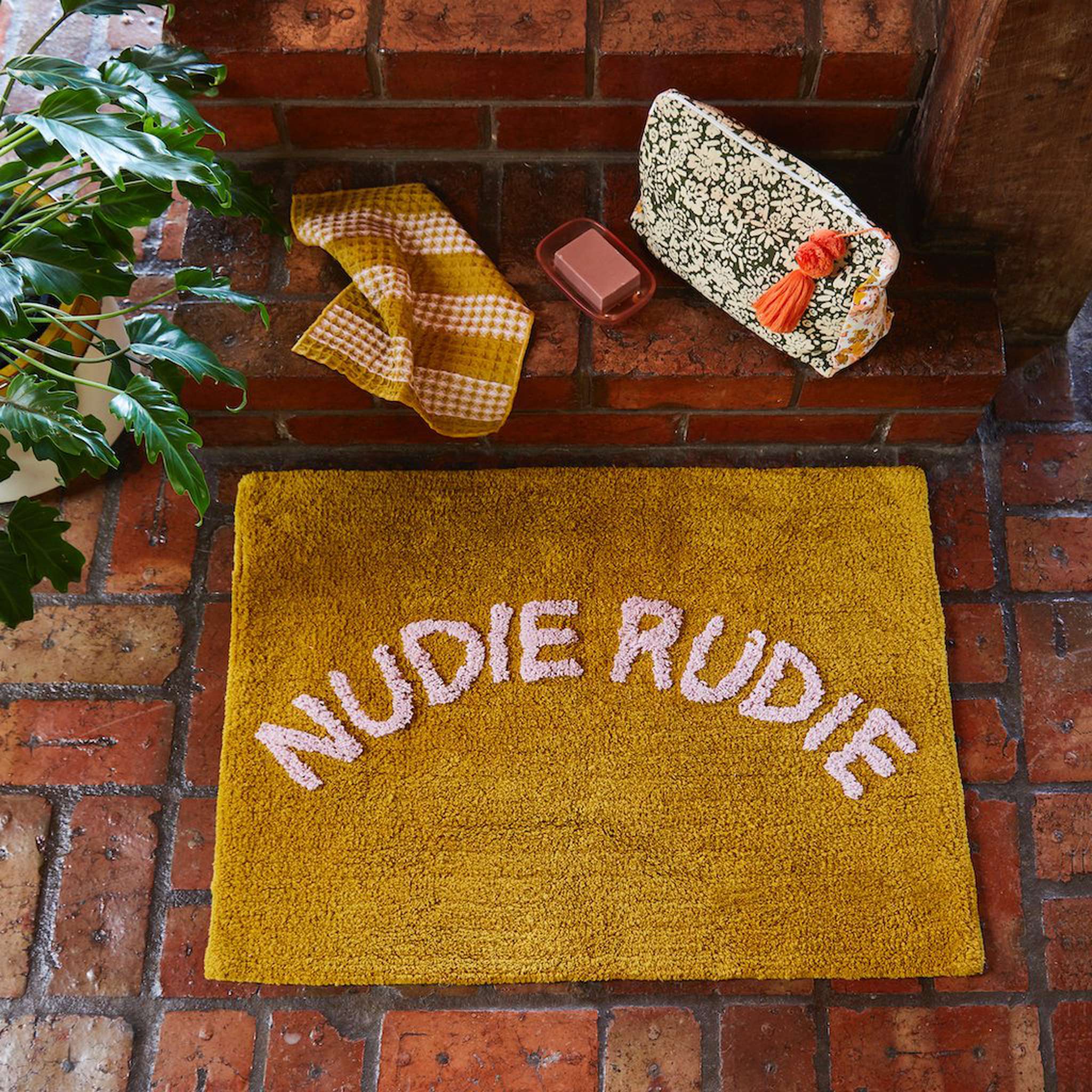 tula tufted pear and lilac bath mat with nudie rudie writing
